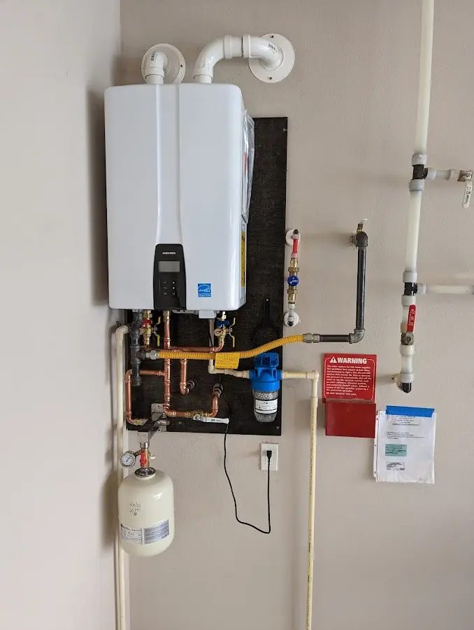 Professional plumber installing copper piping in a Steger home